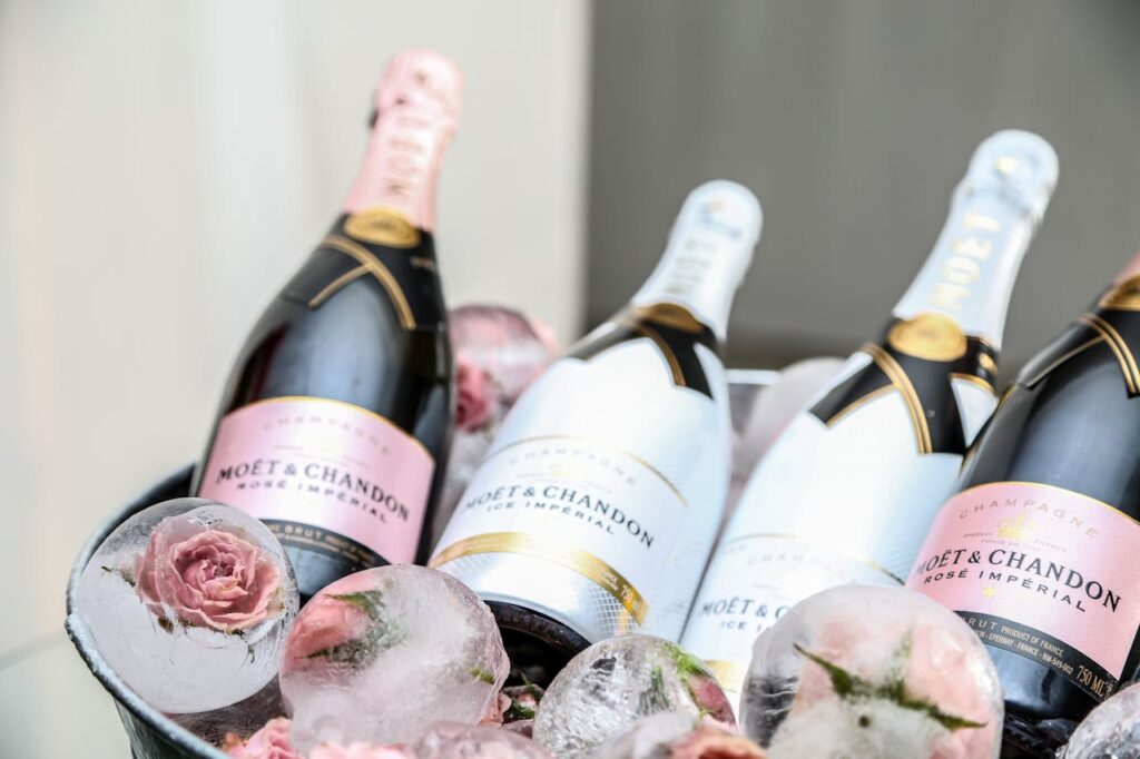 Elegant display of Moet & Chandon champagne in an ice bucket adorned with roses, perfect for celebrations.